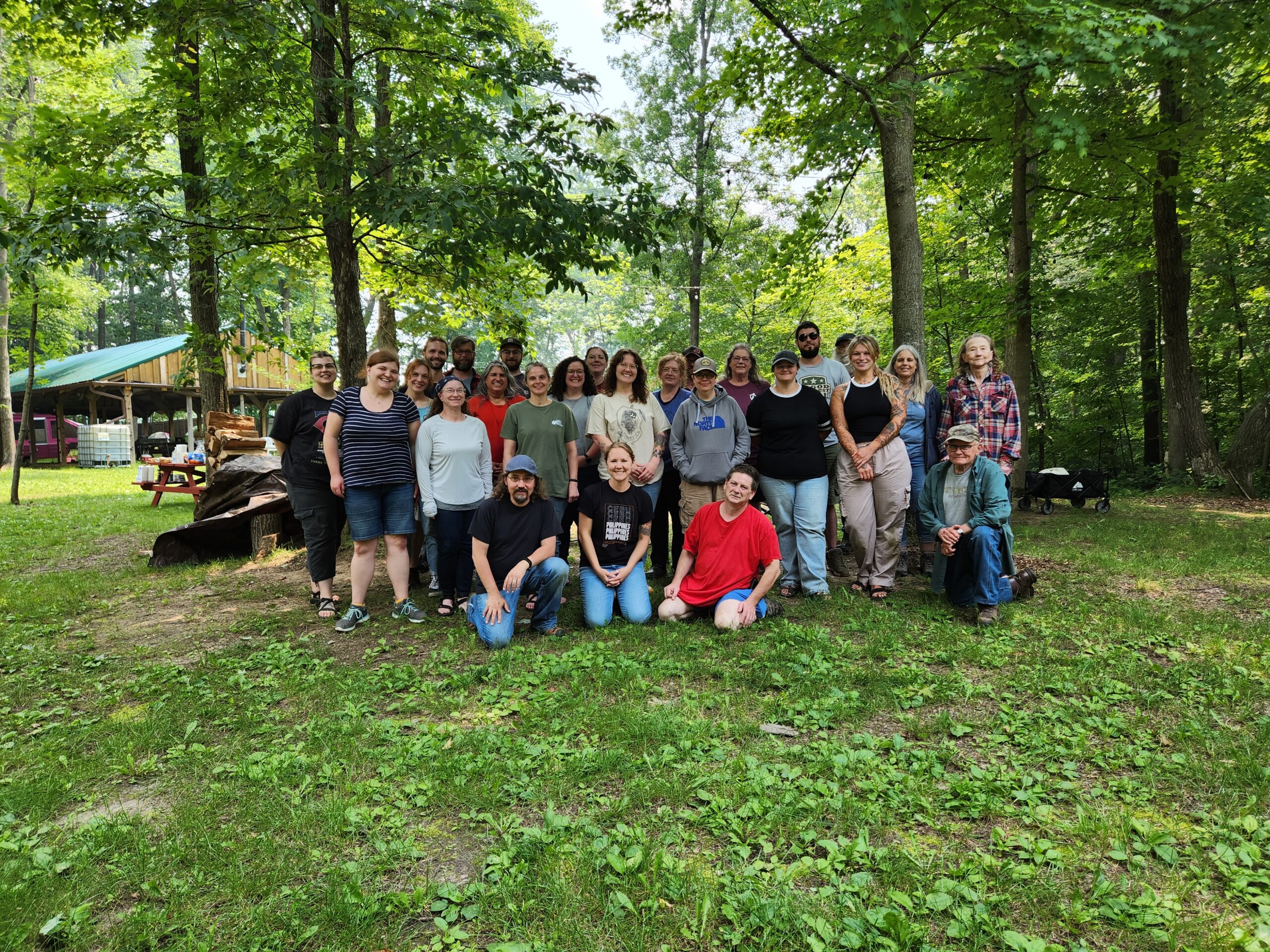group of people smiling at a campground
