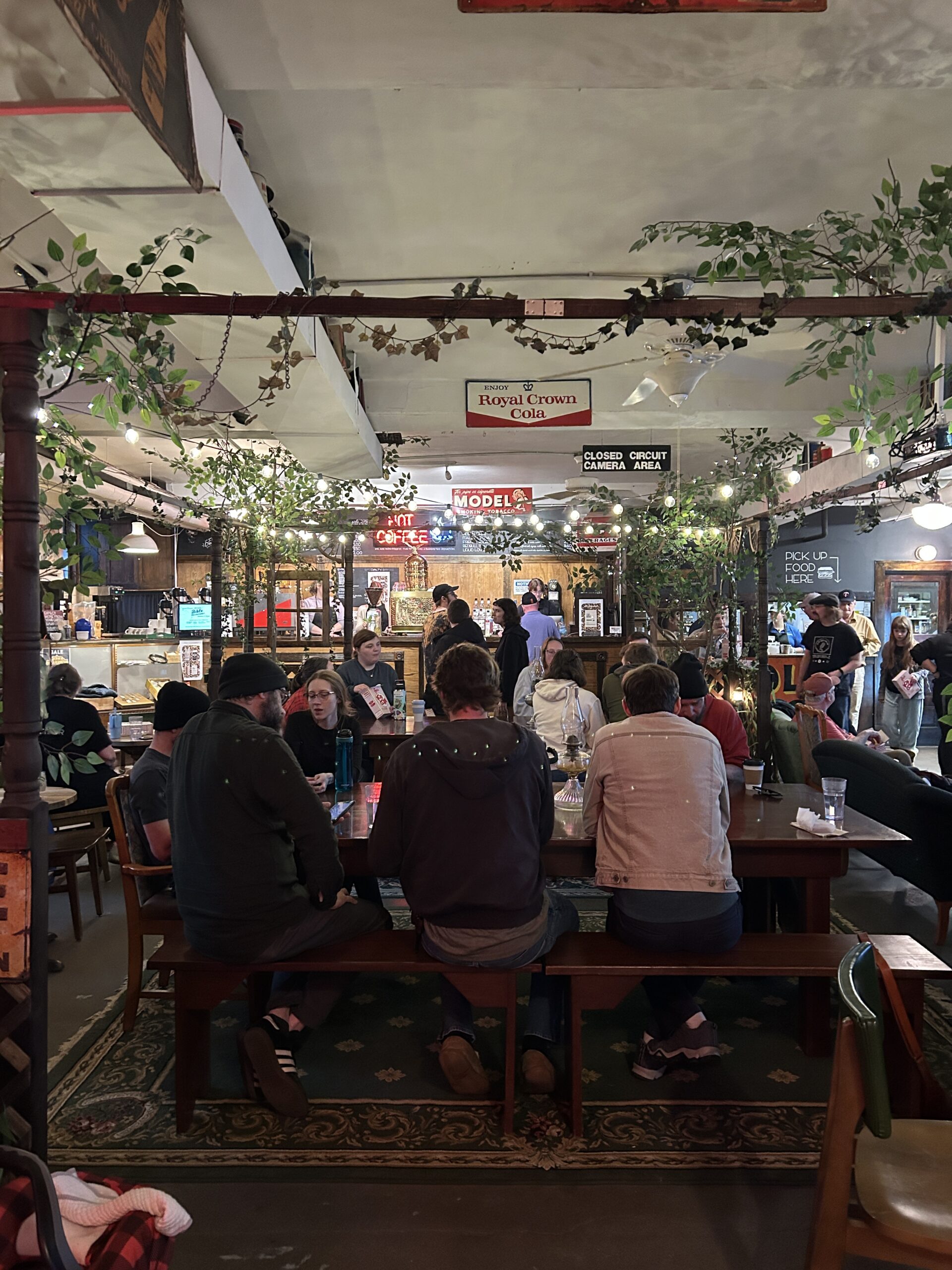 group of people smiling and talking in a coffeehouse