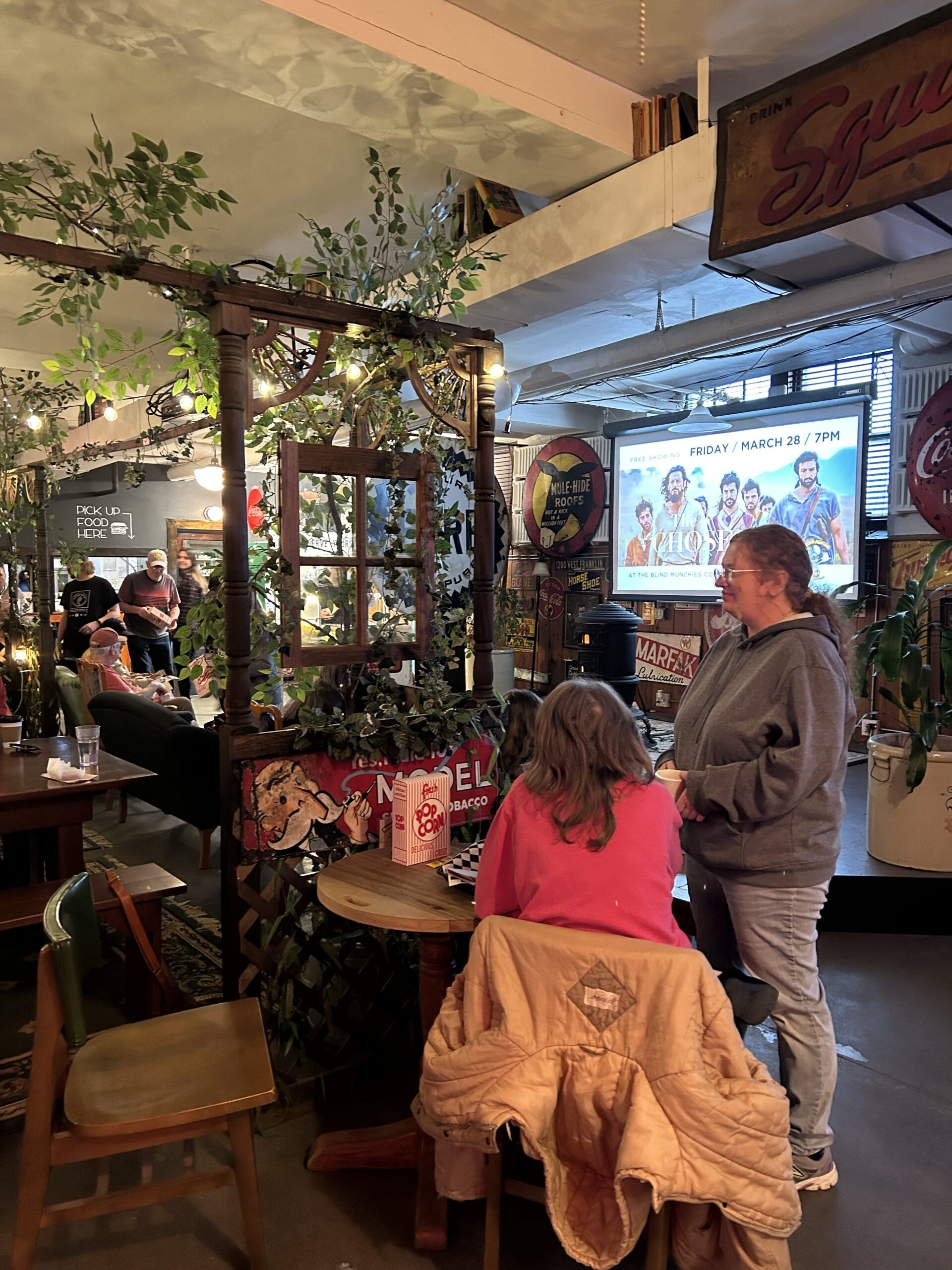 group of people smiling and talking in a coffeehouse