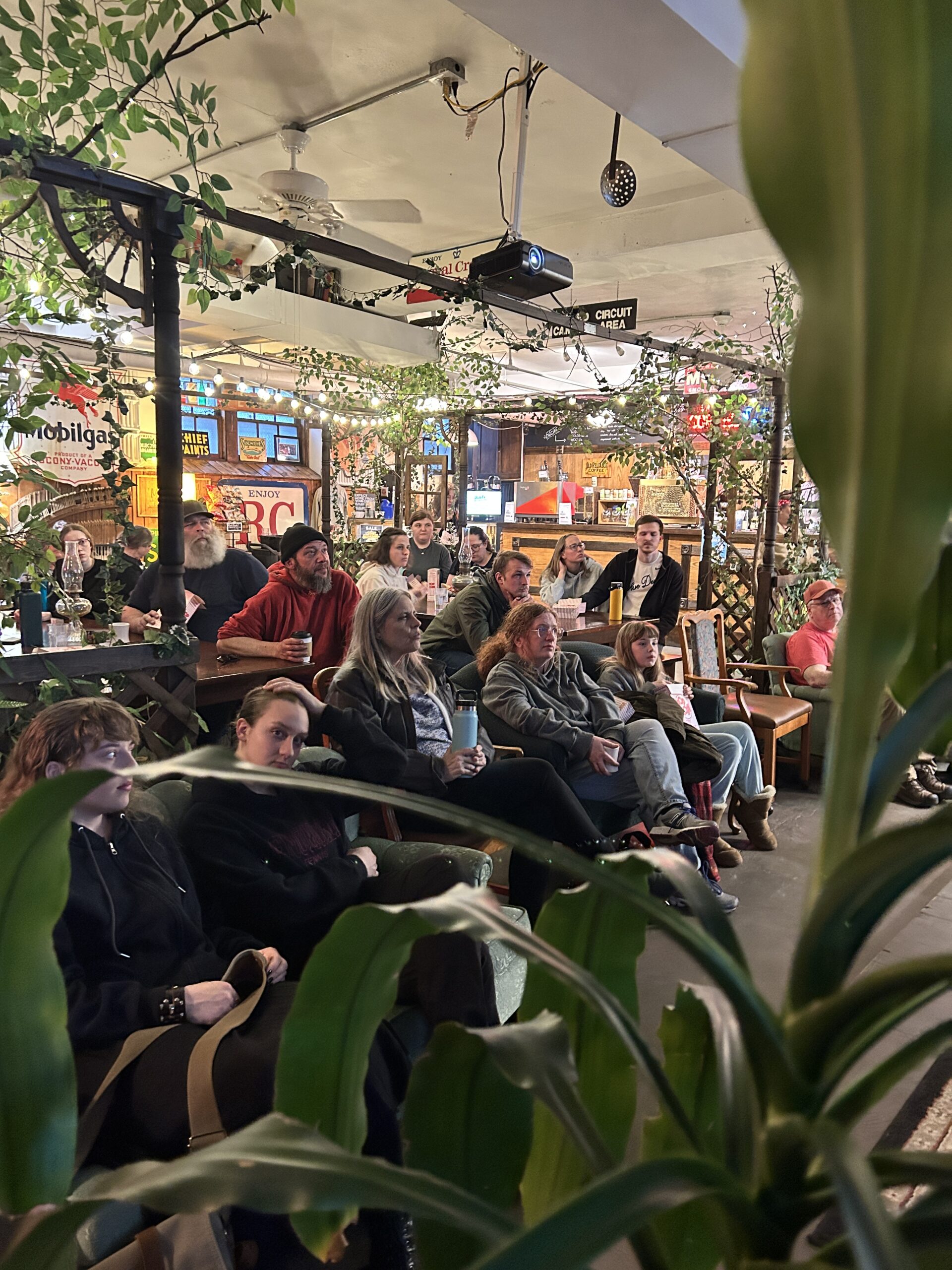 group of people watching a movie in a coffeehouse
