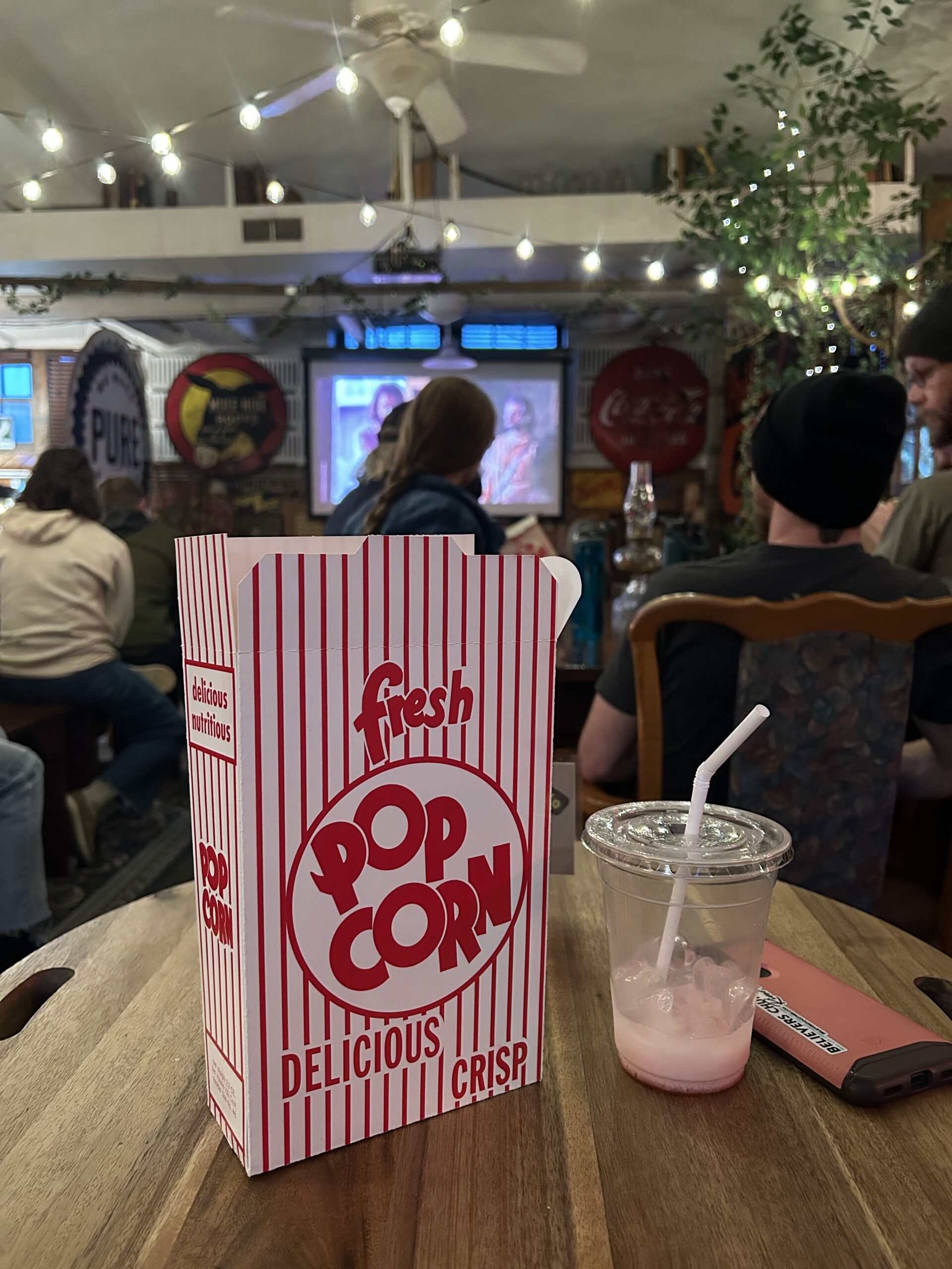 box of popcorn and iced beverage 