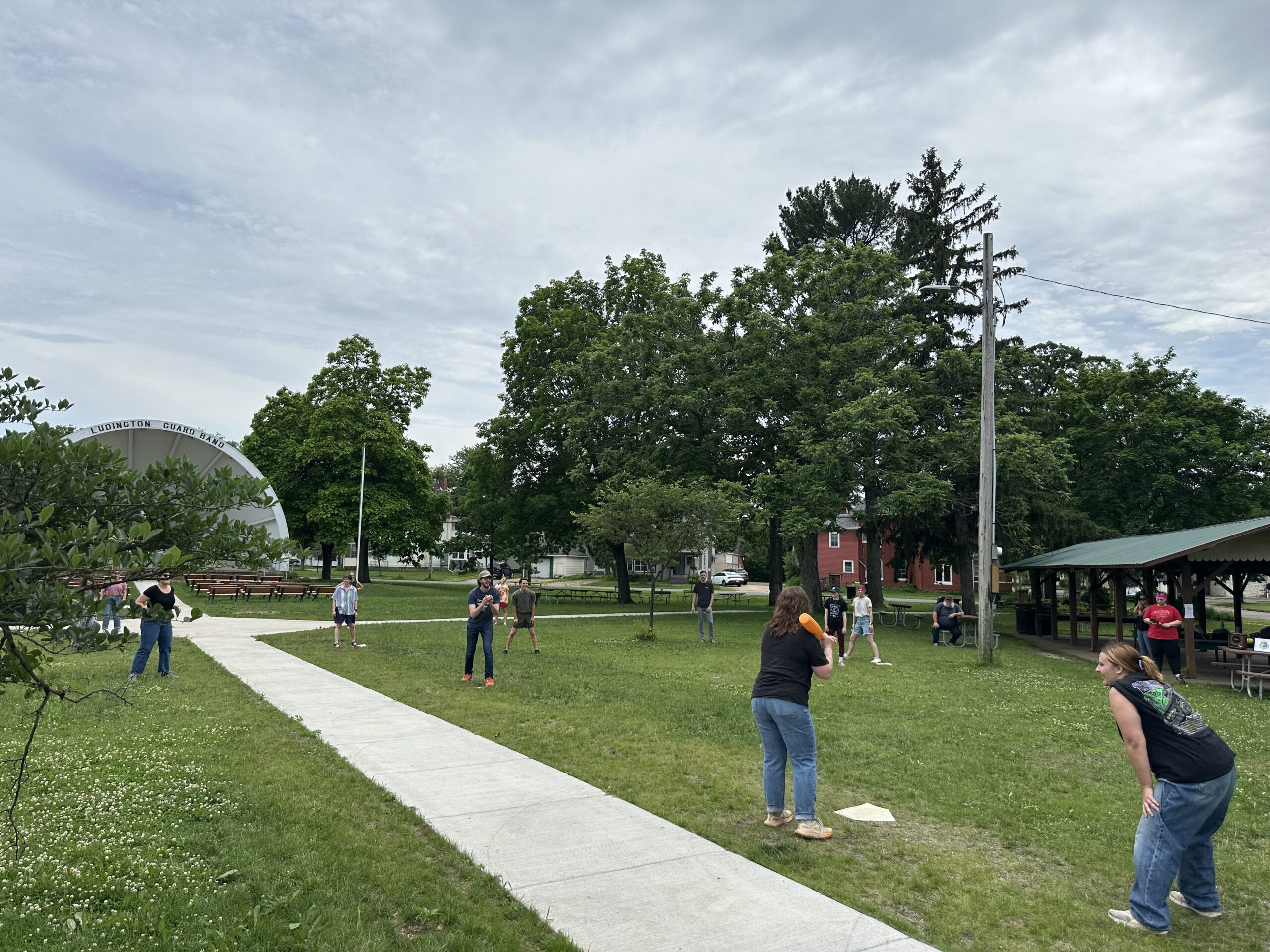 people playing wiffle ball in a park in menomonie